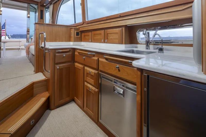 Slide: The Image of Luxurious 2018 Sabre 45 Salon Express yacht interior with modern kitchen and wooden cabinetry. - 23