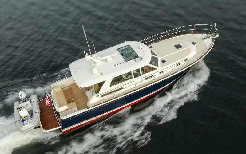 Slide: The Image of 2018 Sabre 45 Salon Express yacht cruising on open water, aerial view. - 3