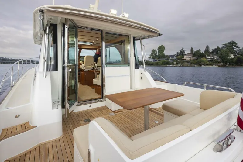 Slide: The Image of 2018 Sabre 45 Salon Express yacht with outdoor seating and table on deck. - 6