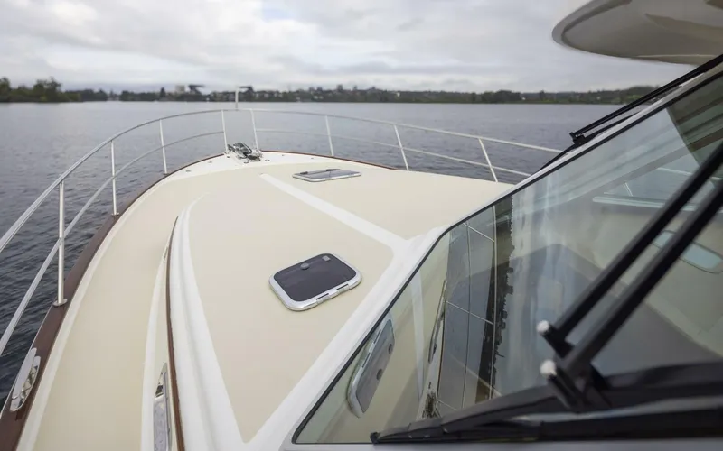 Slide: The Image of 2018 Sabre 45 Salon Express yacht on calm waters, showcasing sleek deck design. - 7