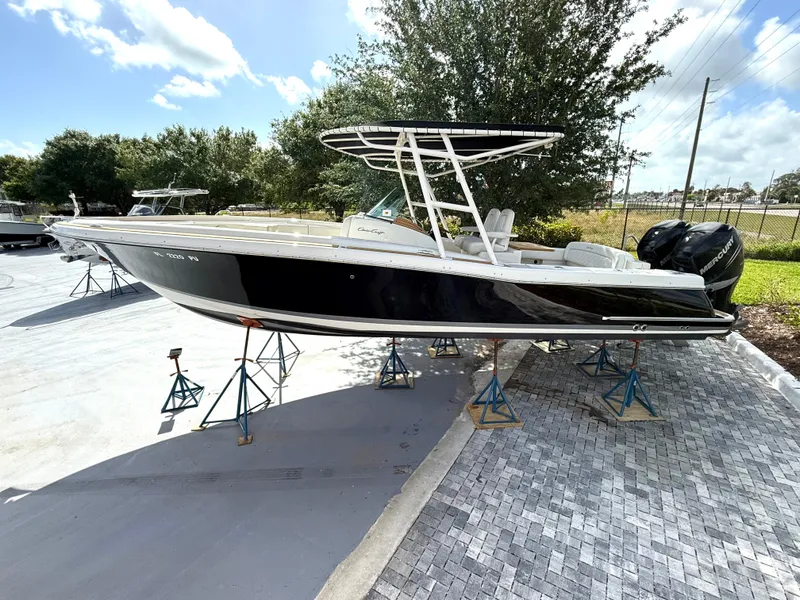Slide: The Image of 2014 Chris-Craft Catalina 29 boat on stands, black hull, outdoor setting. - 1