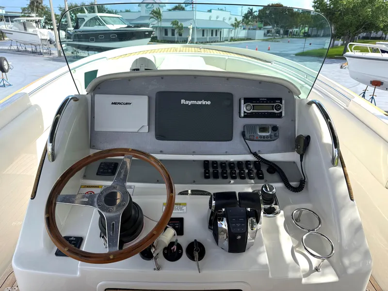 Slide: The Image of 2014 Chris-Craft Catalina 29 helm with Raymarine electronics and wooden steering wheel. - 12