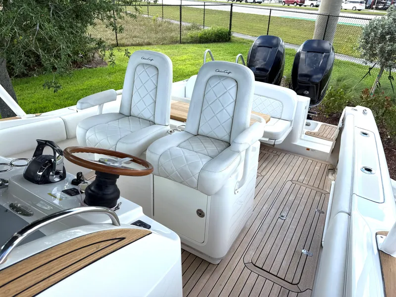 Slide: The Image of 2014 Chris-Craft Catalina 29 boat interior with white seating and wooden accents. - 13