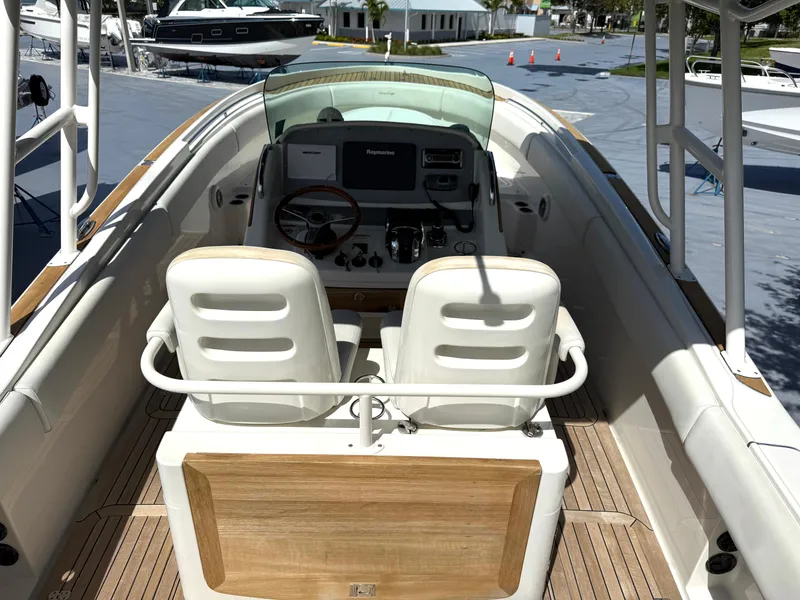 Slide: The Image of 2014 Chris-Craft Catalina 29 boat interior with dual seats and steering console. - 14