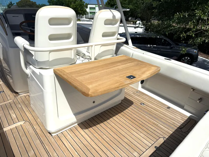 Slide: The Image of 2014 Chris-Craft Catalina 29 boat interior with wooden deck and seating area. - 15