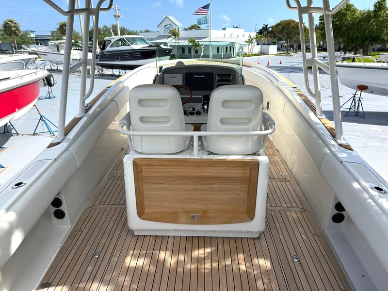 Slide: The Image of 2014 Chris-Craft Catalina 29 boat interior with dual seats and wooden deck. - 17