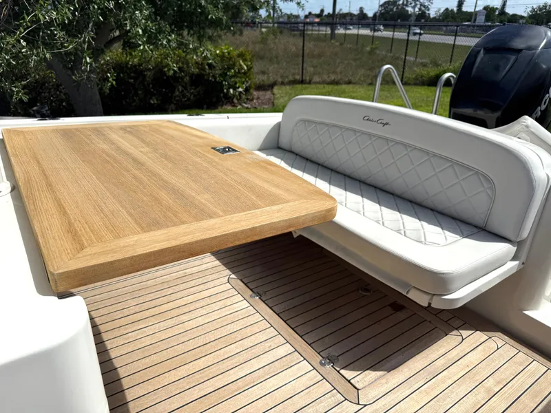 Slide: The Image of 2014 Chris-Craft Catalina 29 boat with teak table and cushioned seating. - 18