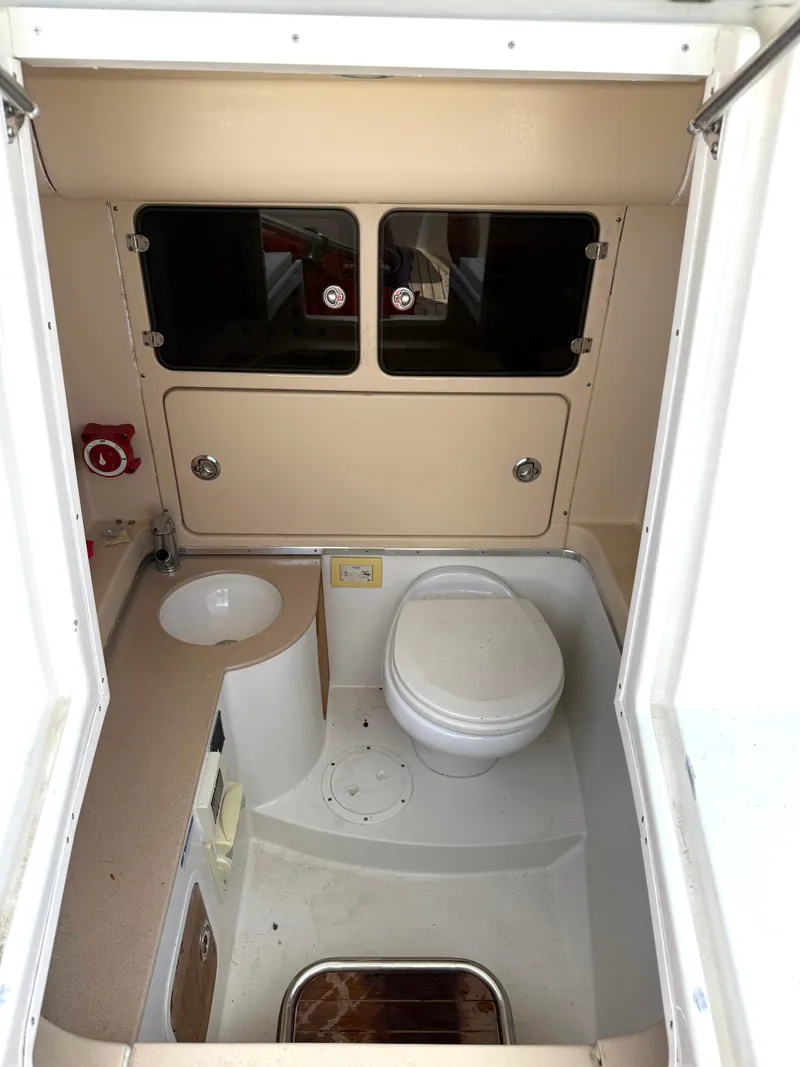 Slide: The Image of 2014 Chris-Craft Catalina 29 boat bathroom interior with toilet and sink. - 20