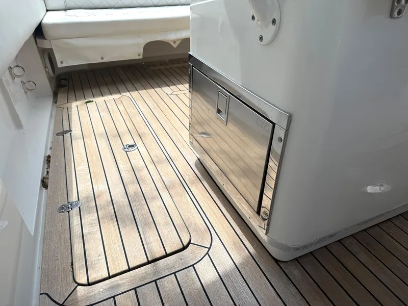 Slide: The Image of 2014 Chris-Craft Catalina 29 interior with teak flooring and stainless steel storage. - 21