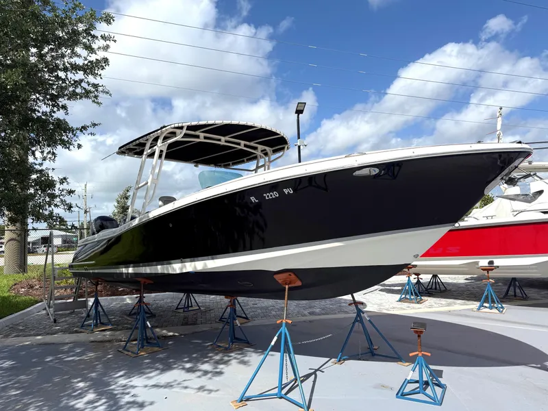 Slide: The Image of 2014 Chris-Craft Catalina 29 boat on stands, under a clear blue sky. - 6