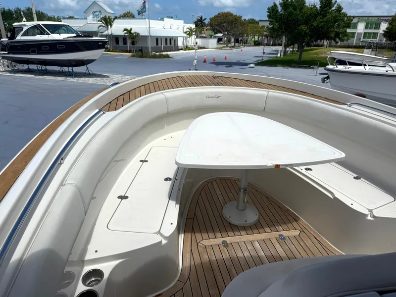 Slide: The Image of 2014 Chris-Craft Catalina 29 boat with teak deck and seating area, docked at marina. - 7