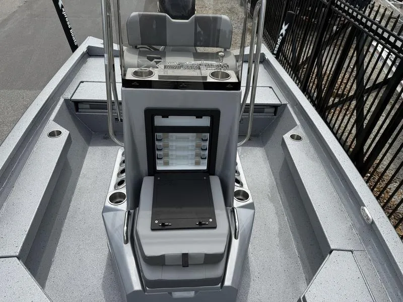 Slide: The Image of 2025 Xpress H20B boat interior with console and seating, featuring modern design and storage. - 10