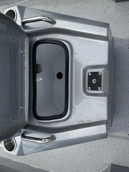 Slide: The Image of 2025 Xpress H20B boat storage compartment with open lid and handles. - 11