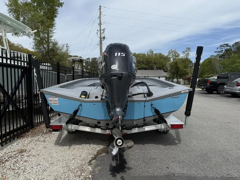 Slide: The Image of 2025 Xpress H20B boat with 115 HP engine on trailer, parked outdoors. - 5