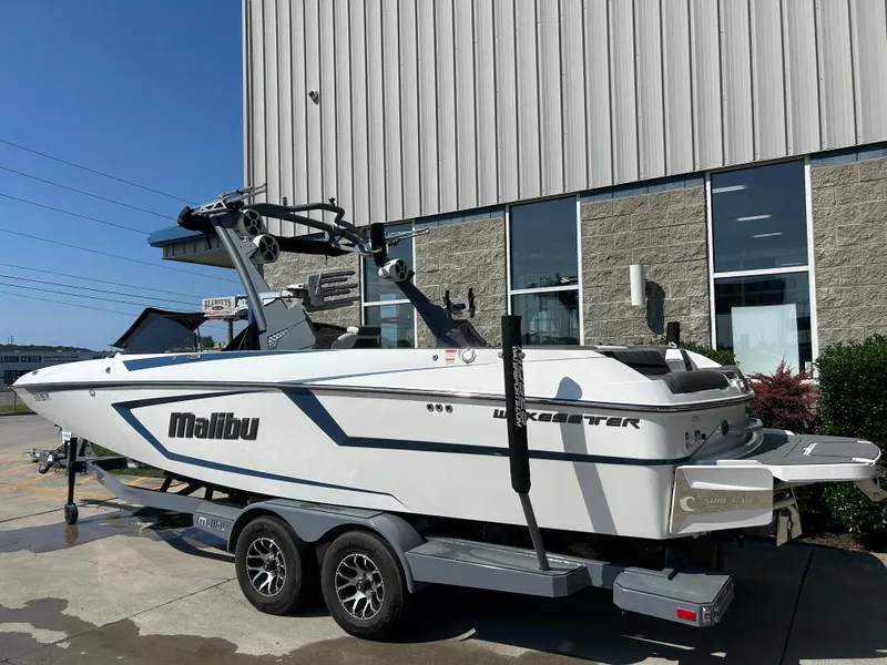 Slide: The Image of 2021 Malibu Wakesetter 24 MXZ boat on trailer outside a building. - 1
