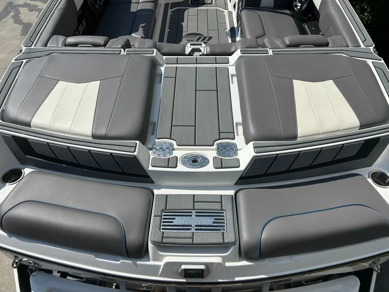 Slide: The Image of 2021 Malibu Wakesetter 24 MXZ boat interior with sleek gray seating and modern design. - 10