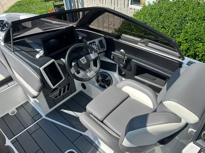 Slide: The Image of 2021 Malibu Wakesetter 24 MXZ boat interior with modern dashboard and seating. - 6