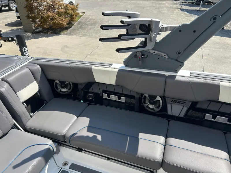 Slide: The Image of 2021 Malibu Wakesetter 24 MXZ interior with gray seating and wakeboard rack. - 7