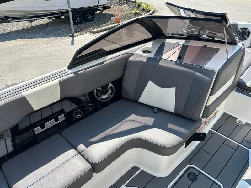 Slide: The Image of 2021 Malibu Wakesetter 24 MXZ interior with gray and white seating, sleek design. - 8