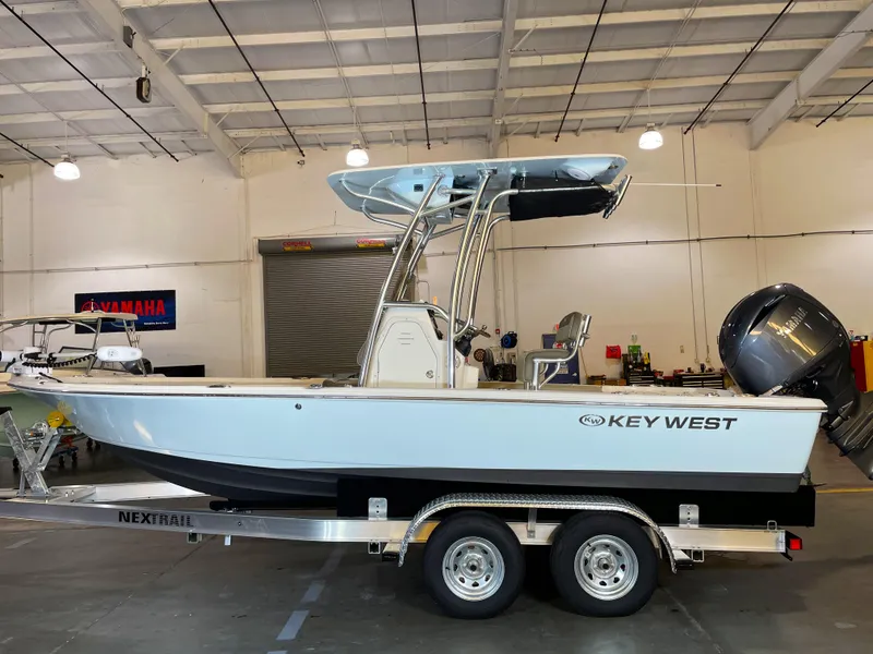 Slide: The Image of 2024 Key West 210 Bay Reef boat on trailer in indoor showroom. - 0