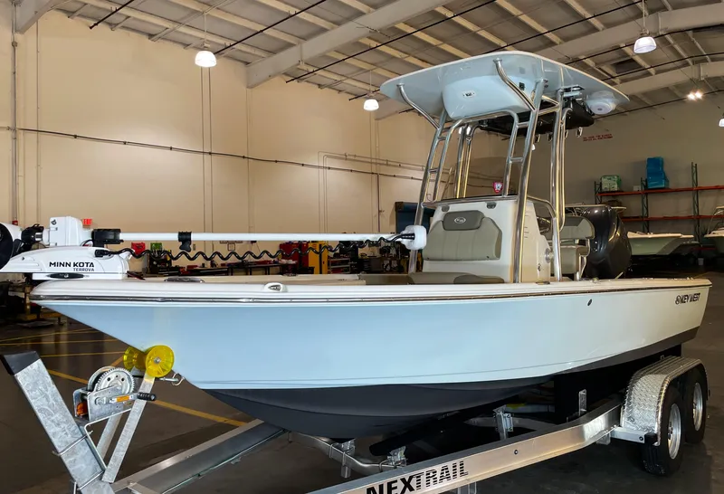 Slide: The Image of 2024 Key West 210 Bay Reef boat on trailer in indoor showroom. - 1
