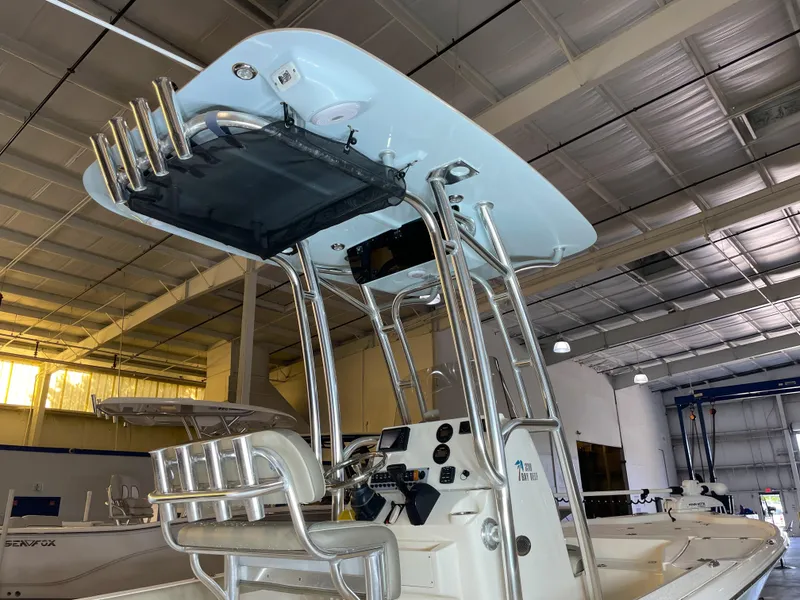 Slide: The Image of 2024 Key West 210 Bay Reef boat interior with T-top and control panel in showroom. - 11