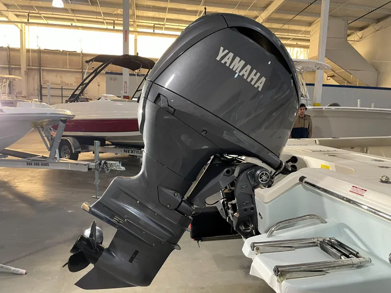 Slide: The Image of 2024 Key West 210 Bay Reef with Yamaha outboard motor in showroom. - 14