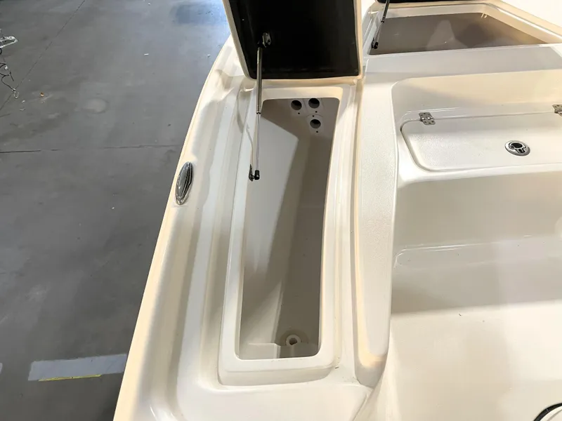 Slide: The Image of 2024 Key West 210 Bay Reef boat storage compartment with open lid. - 20