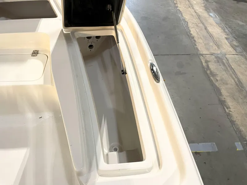 Slide: The Image of 2024 Key West 210 Bay Reef boat storage compartment, open lid, interior view. - 21