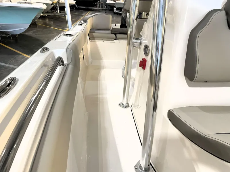 Slide: The Image of 2024 Key West 210 Bay Reef boat interior with seating and stainless steel railings. - 24