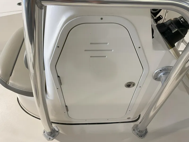 Slide: The Image of 2024 Key West 210 Bay Reef boat console with storage compartment and stainless steel railings. - 26