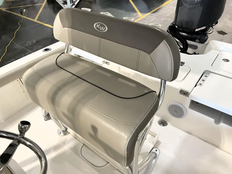 Slide: The Image of 2024 Key West 210 Bay Reef boat seat with beige upholstery and KW logo. - 28