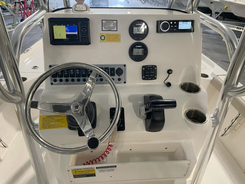 Slide: The Image of 2024 Key West 210 Bay Reef boat console with steering wheel, gauges, and controls. - 29