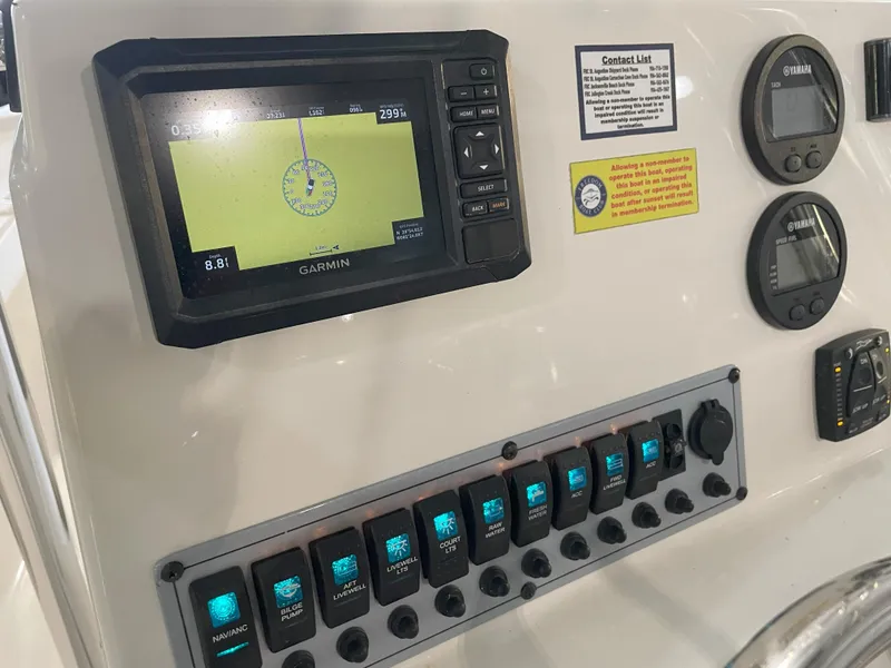 Slide: The Image of 2024 Key West 210 Bay Reef dashboard with Garmin GPS and control switches. - 32