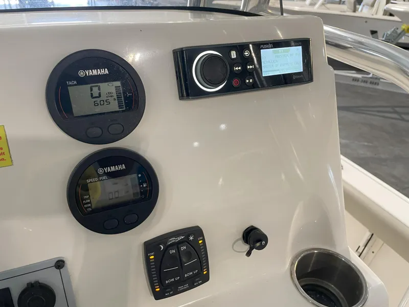 Slide: The Image of 2024 Key West 210 Bay Reef dashboard with Yamaha gauges and audio controls. - 33