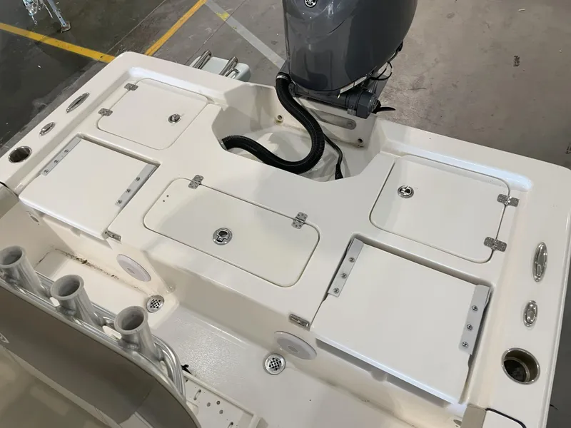 Slide: The Image of 2024 Key West 210 Bay Reef boat deck with storage compartments and motor. - 36