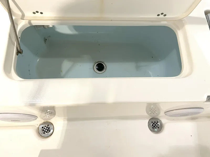 Slide: The Image of 2024 Key West 210 Bay Reef boat livewell with open lid and drainage system. - 38