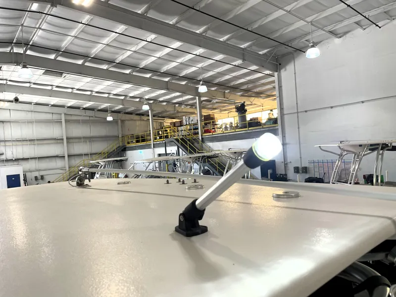 Slide: The Image of 2024 Key West 210 Bay Reef boat in a spacious indoor facility. - 44