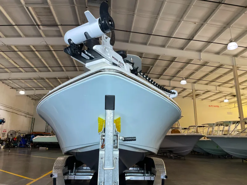Slide: The Image of 2024 Key West 210 Bay Reef boat in a showroom, featuring a Minn Kota trolling motor. - 7