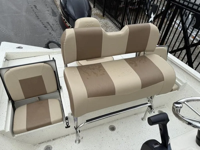 Slide: The Image of 2025 Xpress H20B boat seats with beige and brown upholstery, featuring a steering wheel. - 11