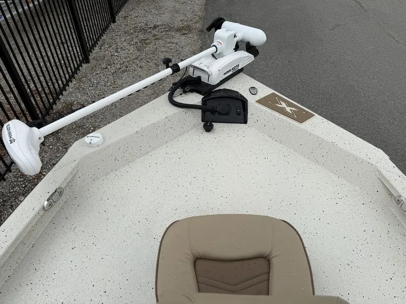 Slide: The Image of 2025 Xpress H20B boat with trolling motor and beige seating on deck. - 7