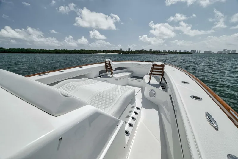 Slide: The Image of 2024 Front Runner 47 Center Console boat on water, featuring sleek design and comfortable seating. - 24
