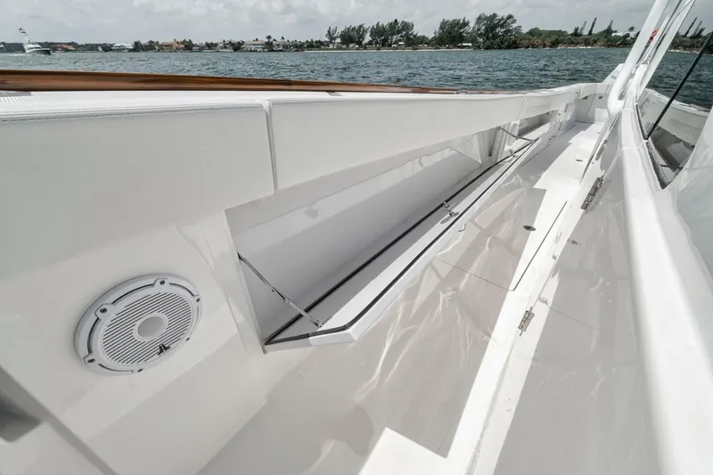 Slide: The Image of 2024 Front Runner 47 Center Console boat deck with storage compartment and speaker. - 25