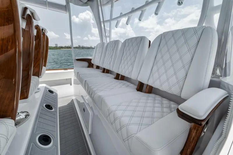Slide: The Image of 2024 Front Runner 47 Center Console boat with luxurious white seating and wooden accents. - 32