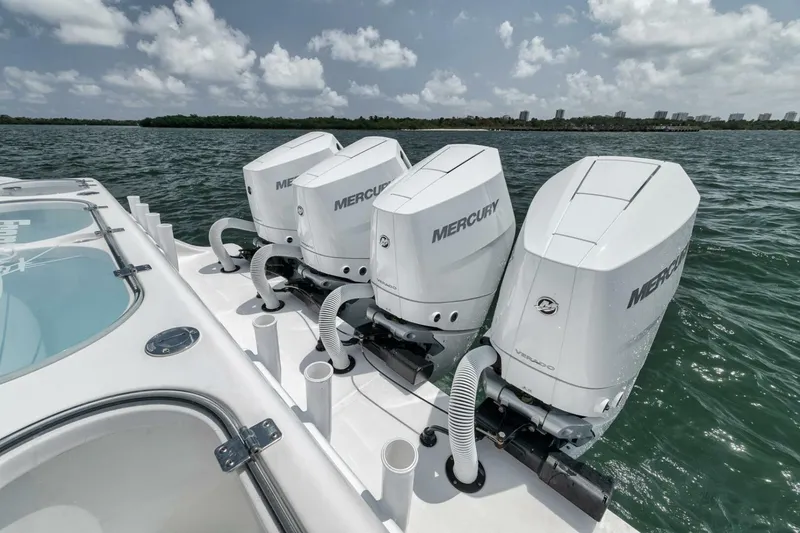 Slide: The Image of 2024 Front Runner 47 Center Console with four Mercury outboard engines on open water. - 35