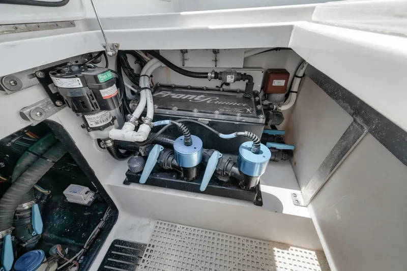 Slide: The Image of 2024 Front Runner 47 Center Console engine compartment with visible components and wiring. - 38