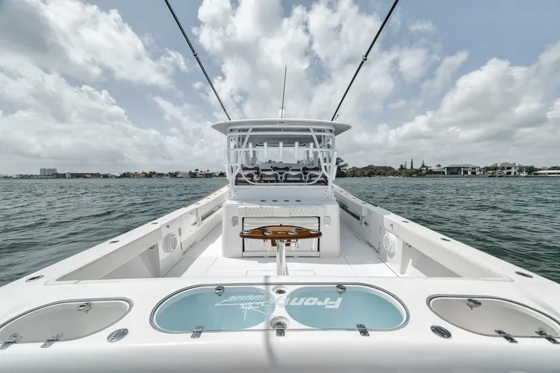 Slide: The Image of 2024 Front Runner 47 Center Console boat on water, showcasing spacious deck and helm. - 39