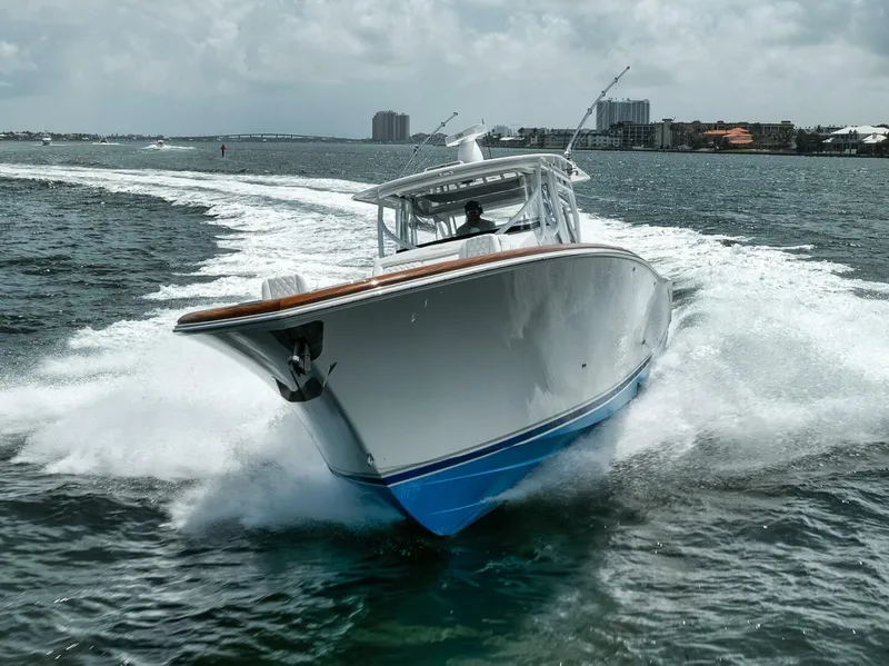 Slide: The Image of 2024 Front Runner 47 Center Console boat cruising on open water, creating a dynamic wake. - 4