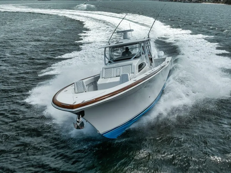 Slide: The Image of 2024 Front Runner 47 Center Console boat cruising swiftly on open water. - 5