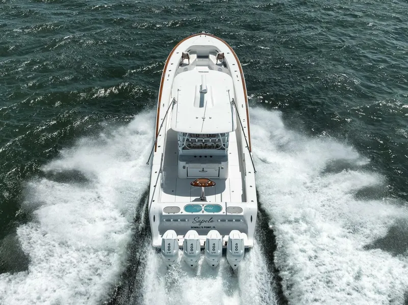 Slide: The Image of 2024 Front Runner 47 Center Console boat cruising on open water, rear view. - 7